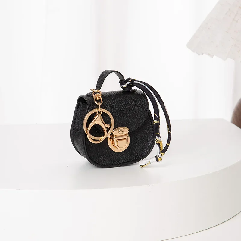 pochette porte-clés multifonctionnelle et portable, tendance et polyvalente, en forme de selle, avec porte-monnaie et étui de rangement pour écouteurs sans fil.