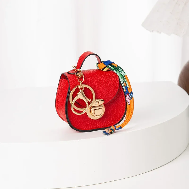 pochette porte-clés multifonctionnelle et portable, tendance et polyvalente, en forme de selle, avec porte-monnaie et étui de rangement pour écouteurs sans fil.