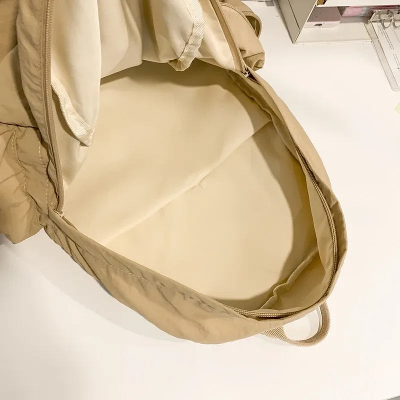 nouveau sac à dos mignon de couleur unie pour femmes, sac à dos de loisirs en nylon pour étudiantes, cartable pour adolescentes, sac à dos de voyage à la mode
