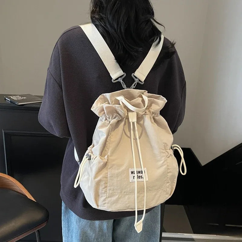 sac en toile polyvalent de grande capacité, décontracté, nouvelle mode d'été 2025, sac à dos à cordon de serrage, concis, couleur unie, sacs d'école légers