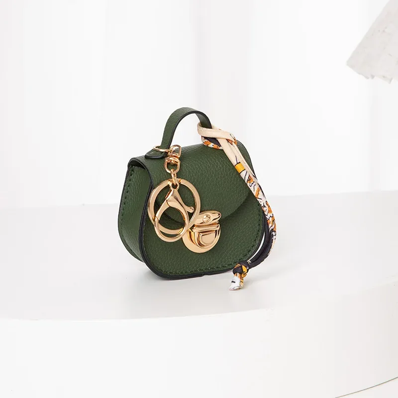 pochette porte-clés multifonctionnelle et portable, tendance et polyvalente, en forme de selle, avec porte-monnaie et étui de rangement pour écouteurs sans fil.
