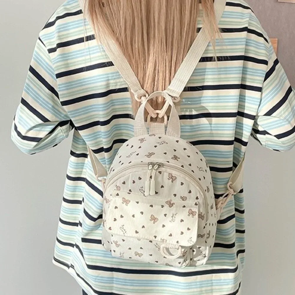 mini sac à dos en velours côtelé imprimé cœurs et nœuds, léger, décontracté, multi-compartiments, ouverture zippée, sac à bandoulière pour les trajets quotidiens