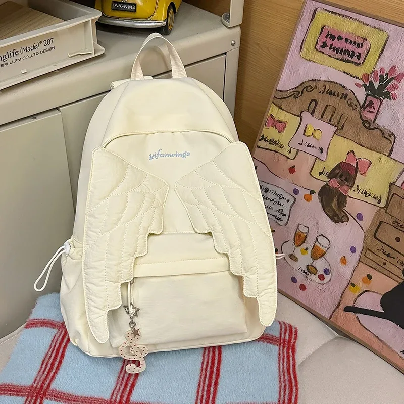 sac à dos ailes d'ange de marque pour filles, niche douce et polyvalente, en toile, nouveau sac de voyage tendance y2k avec pompon, grande capacité
