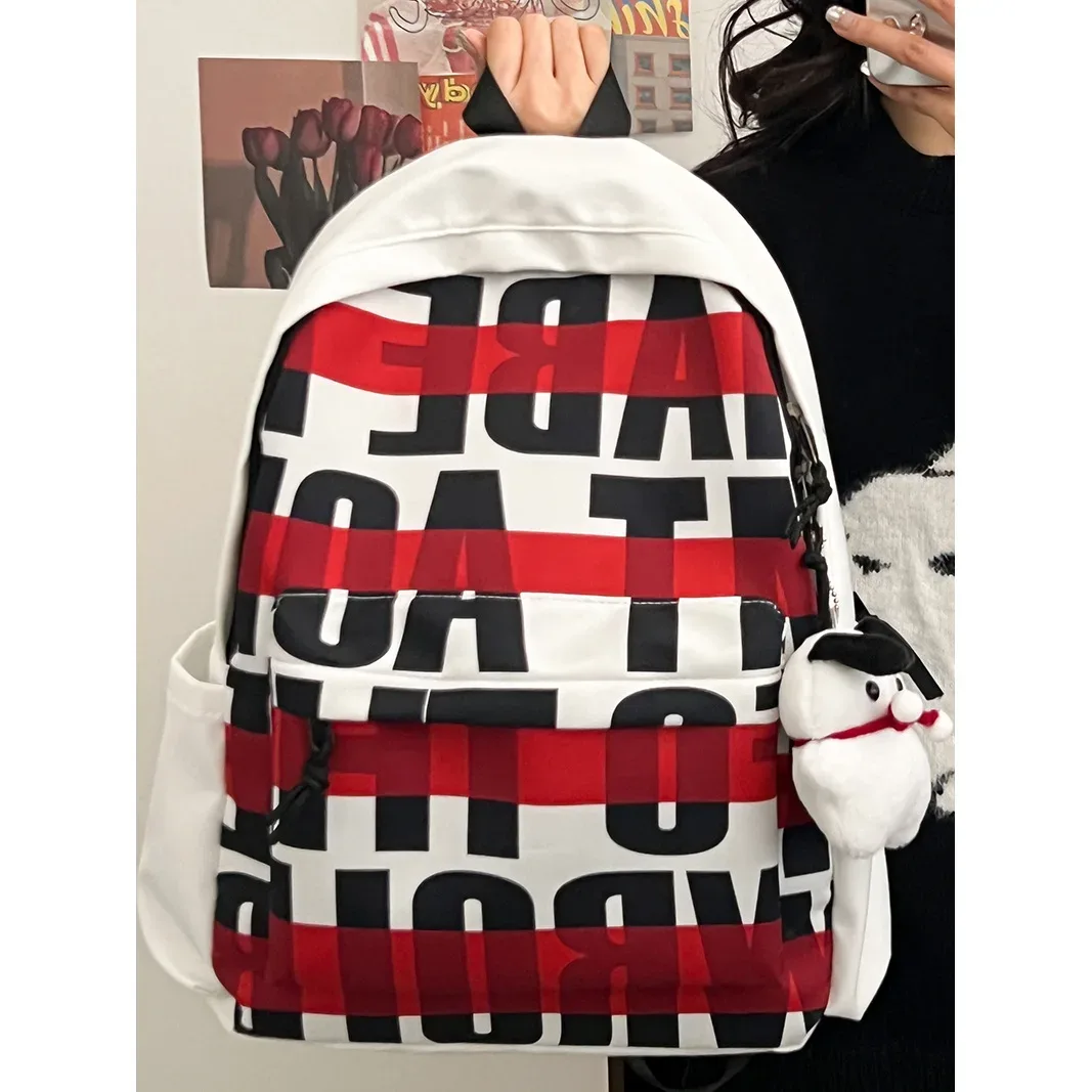 sac à dos blanc minimaliste pour femme, durable et décontracté, avec imprimé lettres et détail breloque chien