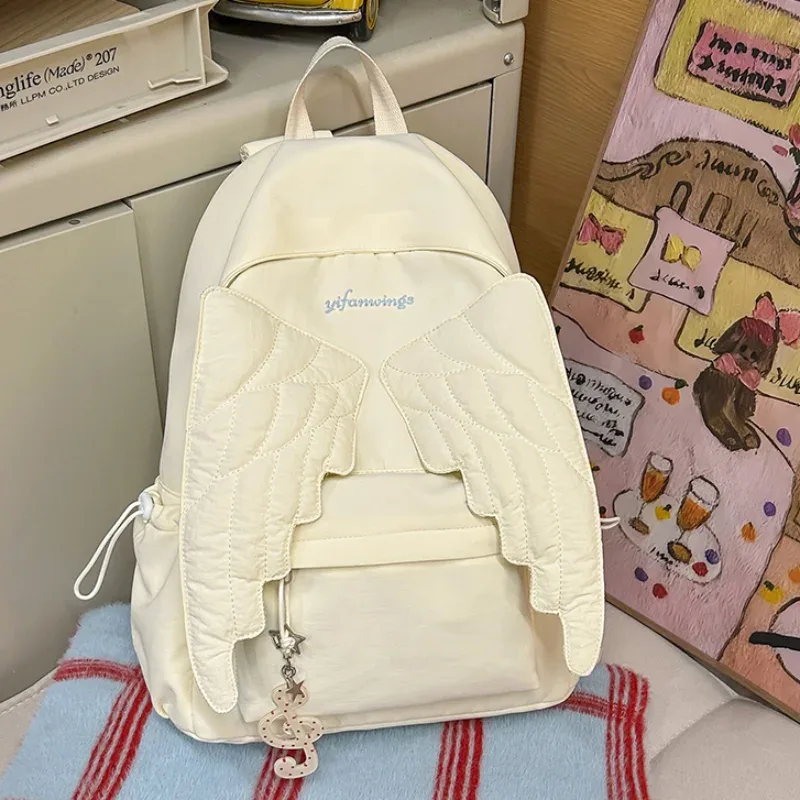 sac à dos à ailes style y2k pour femmes, sac en toile d'ange mignon japonais, pompon créatif, couleur unie, sac à bandoulière de grande capacité pour étudiantes