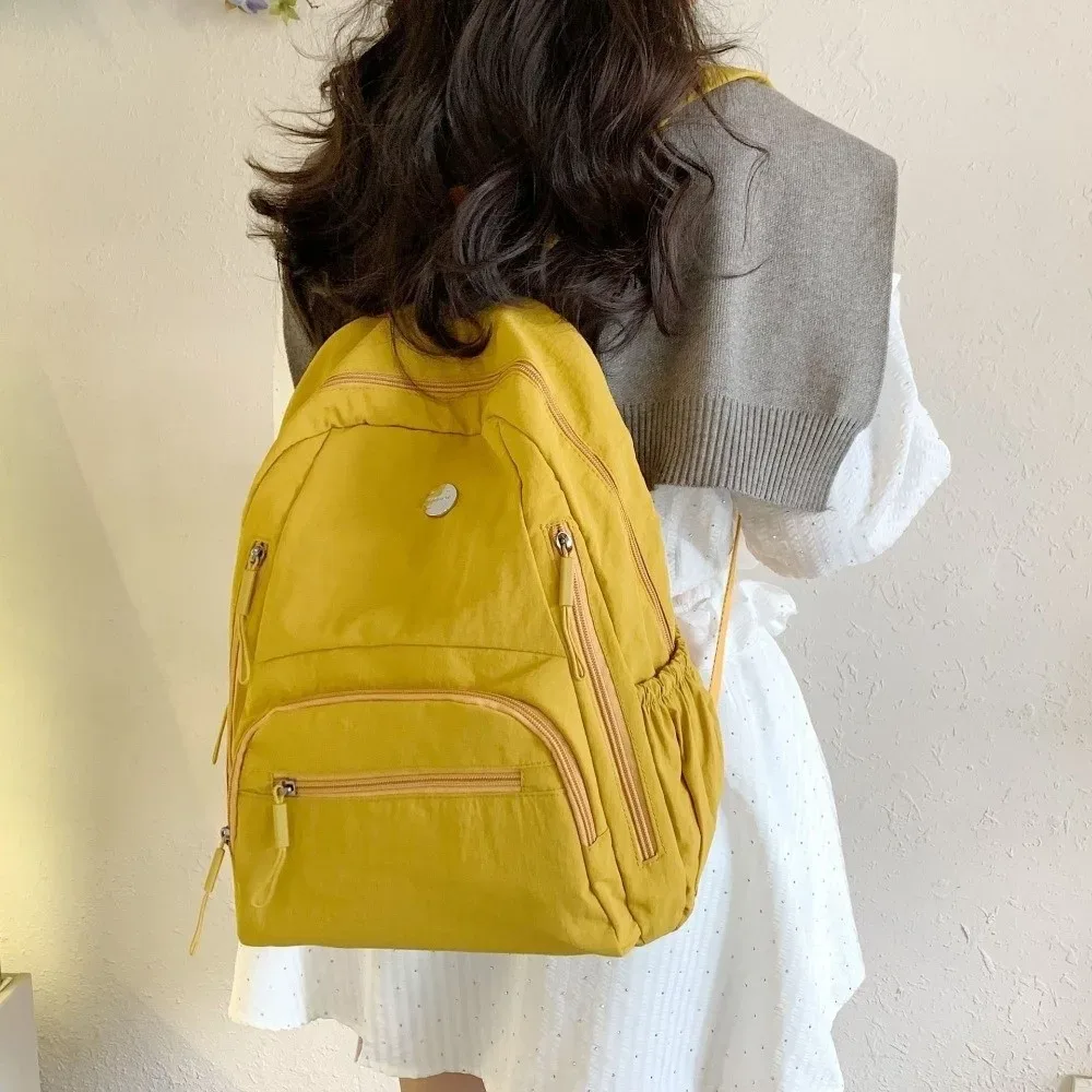 Sac à dos scolaire tendance en nylon grande capacité, léger, durable, imperméable, couleur unie, pour ordinateur portable, idéal pour les voyages et le quotidien