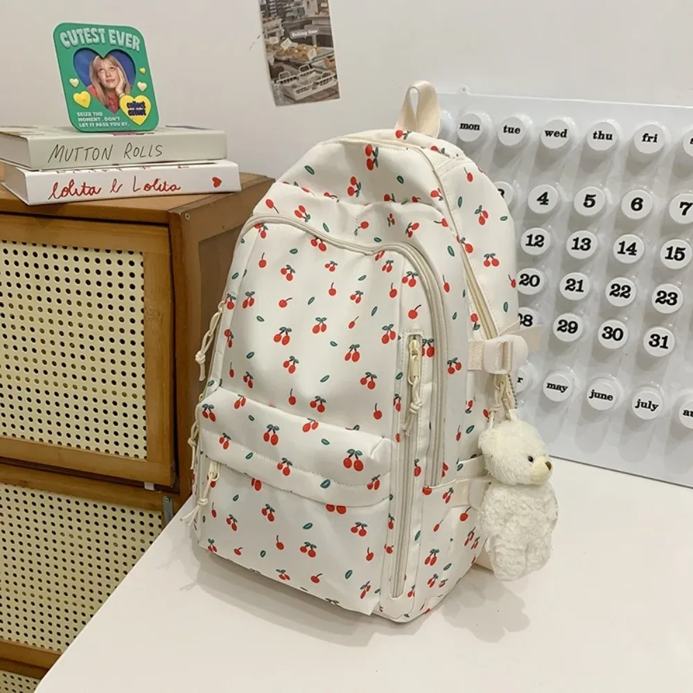 sac d'école en nylon pour étudiants, sac à dos de grande capacité de style preppy pour femmes avec pendentif, sac à dos de voyage à motif floral
