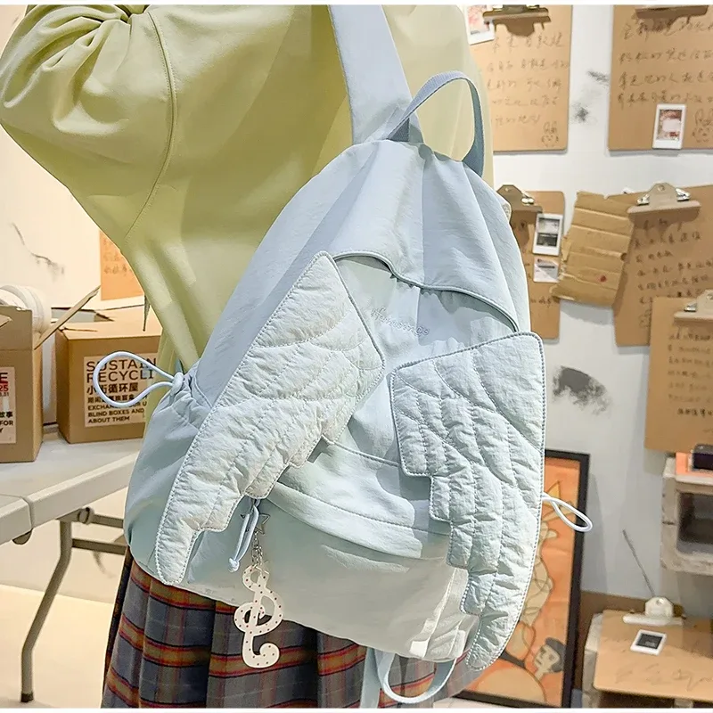 sac à dos ailes d'ange de marque pour filles, niche douce et polyvalente, en toile, nouveau sac de voyage tendance y2k avec pompon, grande capacité
