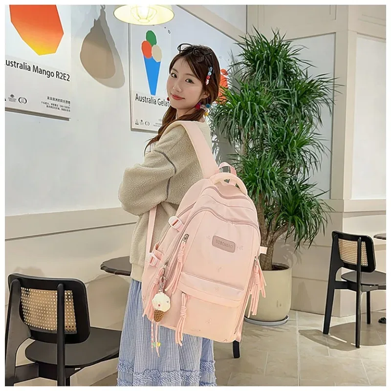 sac à dos traveasy 2026 nouveau motif nœud mignon polyvalent en nylon avec pendentif pompon protection dorsale pour étudiants