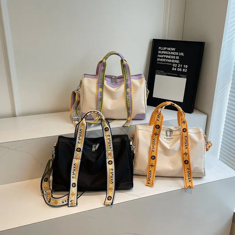 2026 plus récent sac de voyage à main polyvalent à la mode avec lettre sangle sac à bandoulière sac à bagages bagages décontractés Handbabgs