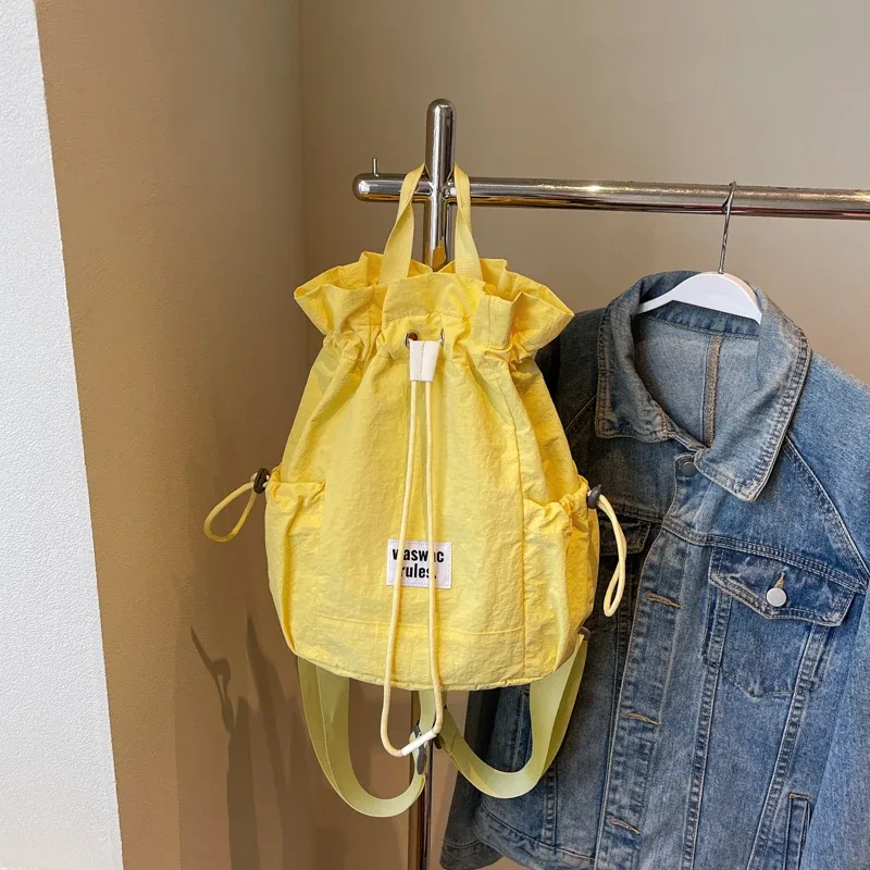 sac en toile polyvalent de grande capacité, décontracté, nouvelle mode d'été 2025, sac à dos à cordon de serrage, concis, couleur unie, sacs d'école légers