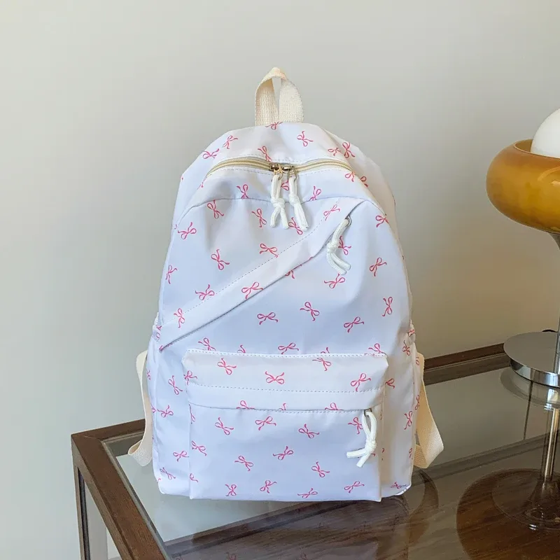 sac à dos tendance et mignon à imprimé nœud pour femme, compartiment pour ordinateur portable avec bretelles réglables, sac idéal pour la rentrée scolaire et les voyages sur le campus