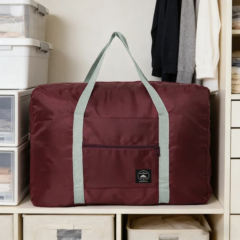 sac de voyage pliable de grande capacité, imperméable et résistant à l'usure, peut être porté à la main et stocké sur une épaule à la maison.