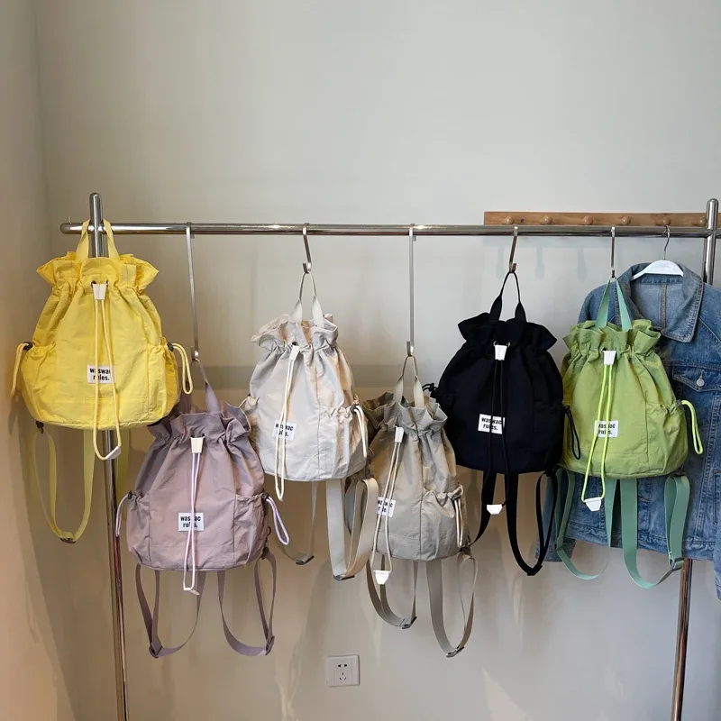 sac en toile polyvalent de grande capacité, décontracté, nouvelle mode d'été 2025, sac à dos à cordon de serrage, concis, couleur unie, sacs d'école légers