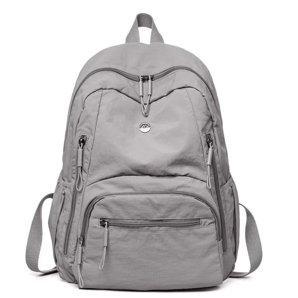 sac à dos minimaliste en nylon de grande capacité, fermeture éclair sécurisée, sac à dos léger et imperméable pour l'école et les voyages.