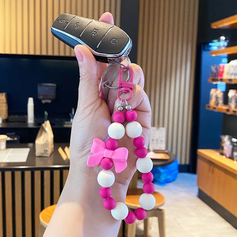 porte-clés avec nœud en perles roses, chaîne pour téléphone portable, sac pour écouteurs, corde anti-perte, porte-clés de voiture, pendentif perlé, accès au pendentif pour sac à dos