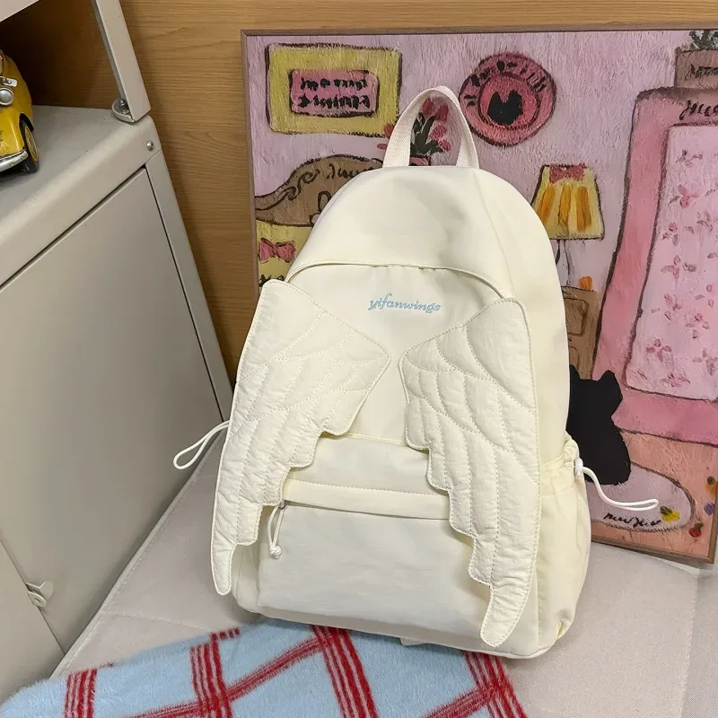 sac à dos ailes d'ange de marque pour filles, niche douce et polyvalente, en toile, nouveau sac de voyage tendance y2k avec pompon, grande capacité