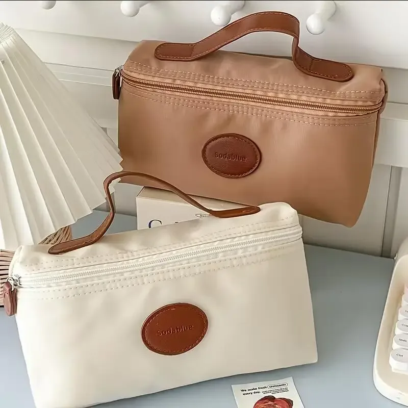 nouvelle trousse de maquillage portable 2026, sac cosmétique à main grande capacité en nylon, trousse de toilette de voyage pour femme, sac de rangement de voyage