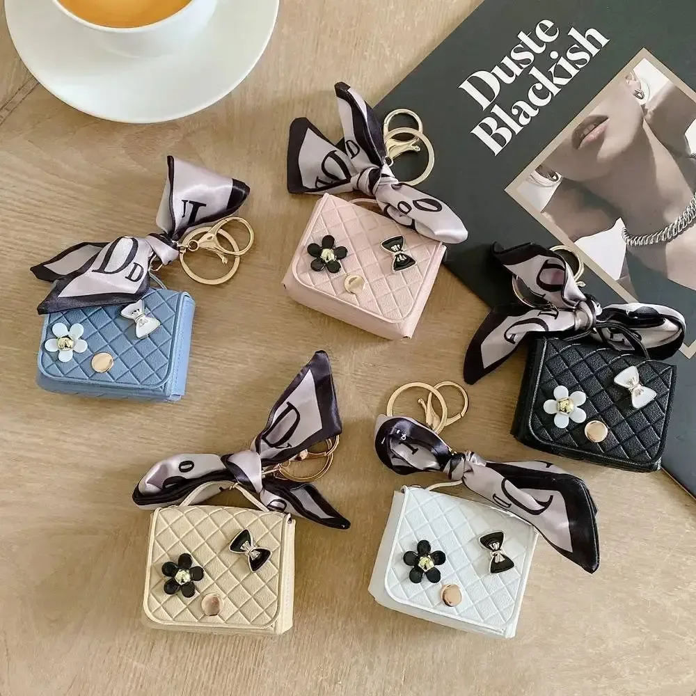 nouvelle pochette de rangement en cuir 2026 pour écouteurs, mini porte-clés créatif, pendentif couleur unie, étui pour écouteurs bluetooth