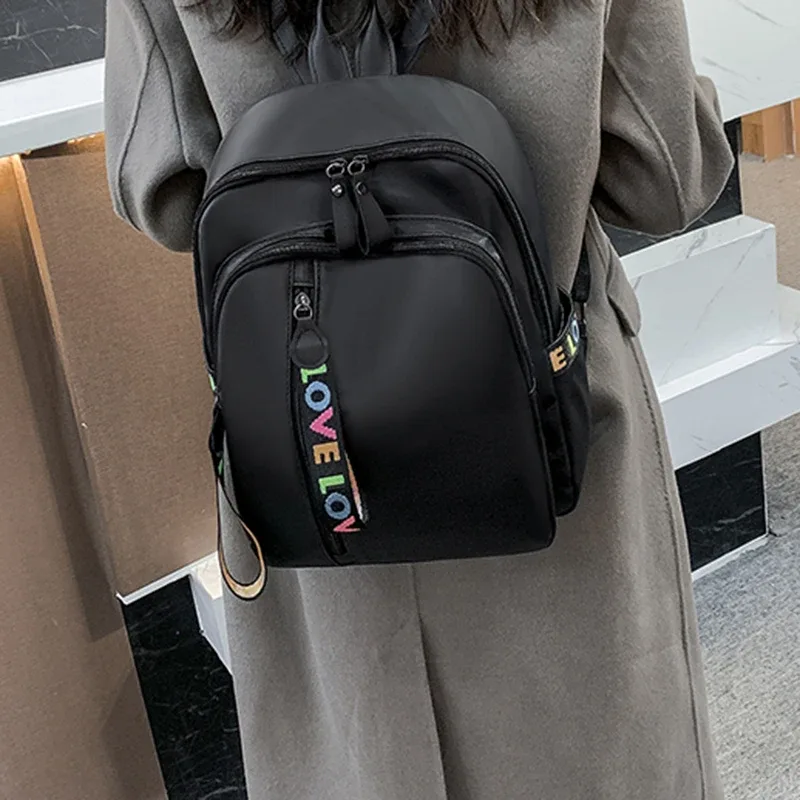sac à dos antivol élégant grace, sac à dos portable en nylon noir avec joli ornement de lettres colorées pour femme, idéal pour le quotidien